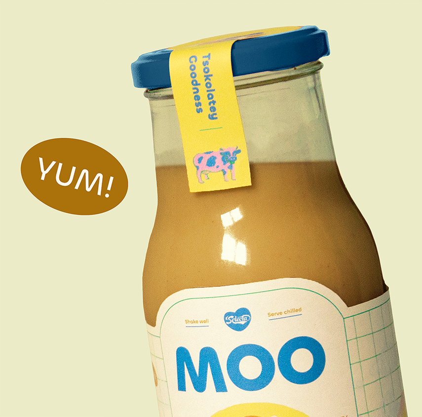 tilted close up shot of moo chocolate bottle with yum sticker